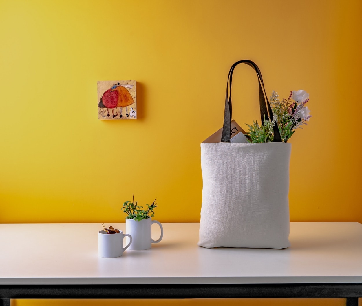 ceramic mugs and white bag sitting on a table