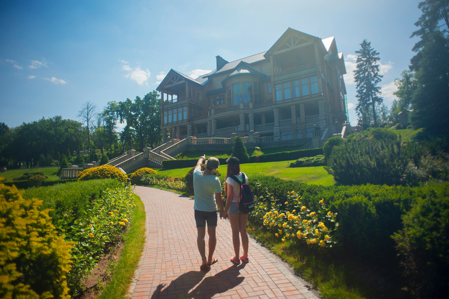 couple pointing at a house