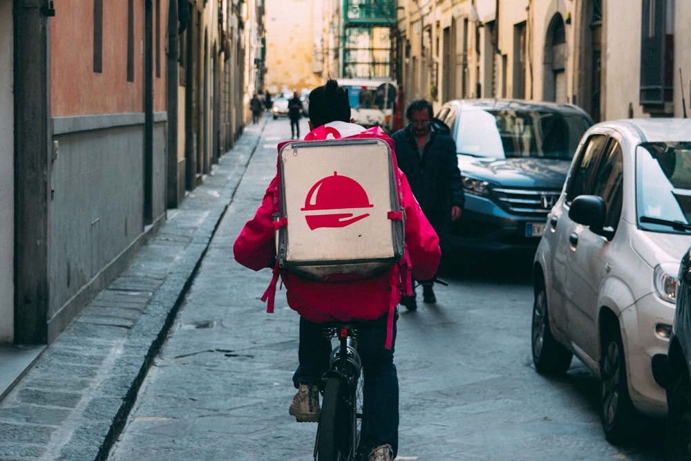 man delivering food on a bicycle