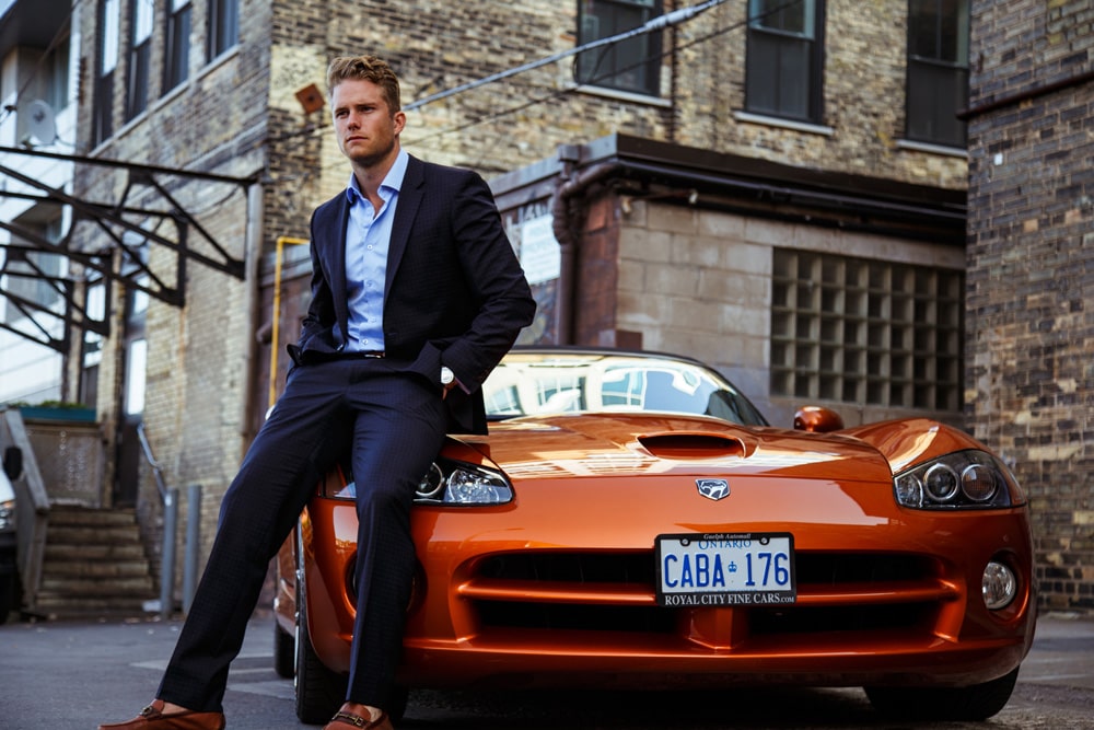 man sitting on the front of car