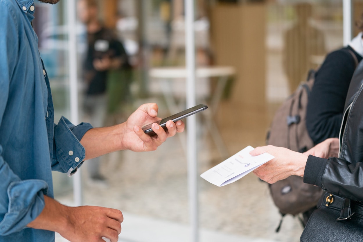 man taking picture of form with his smartphone