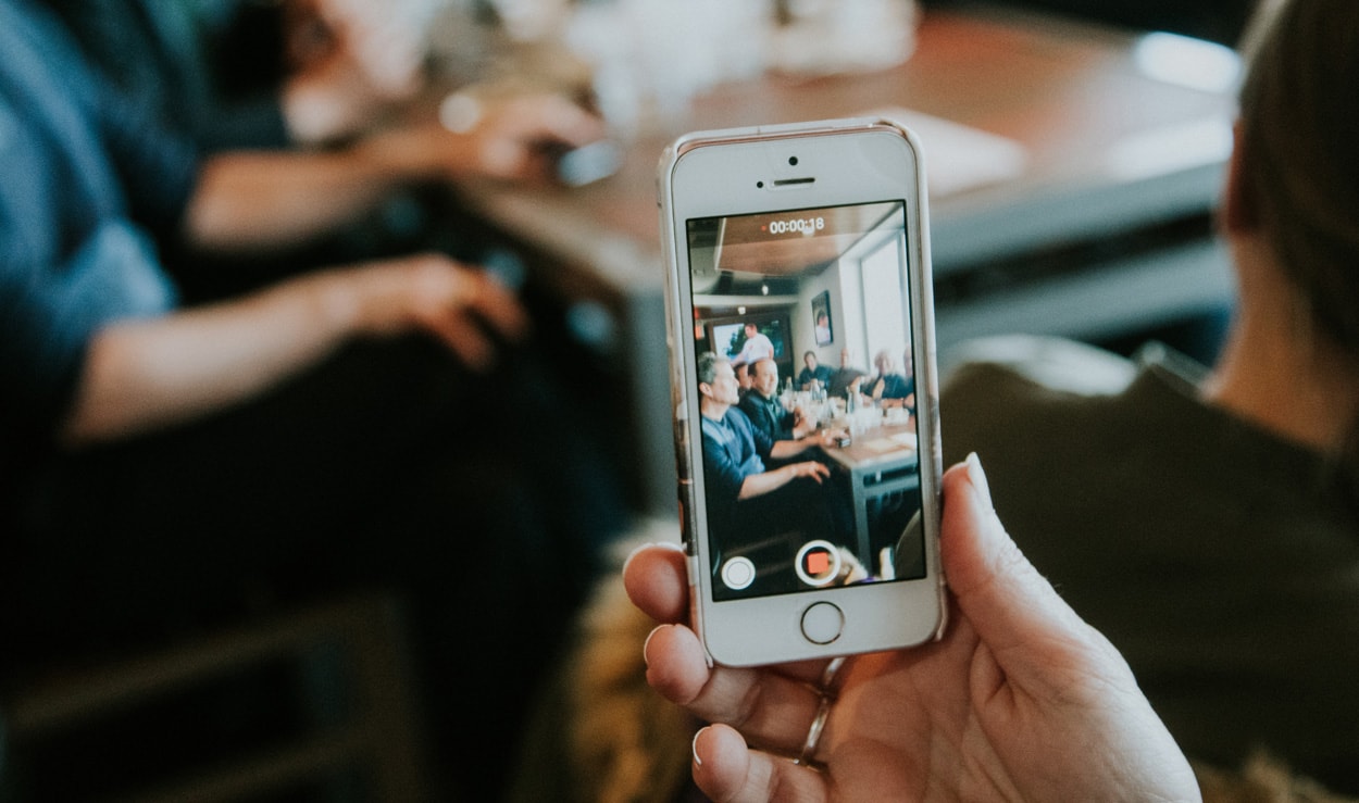 man taking a video of a work meeting