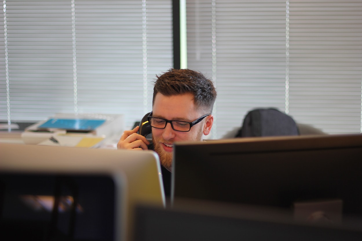 man using phone at work