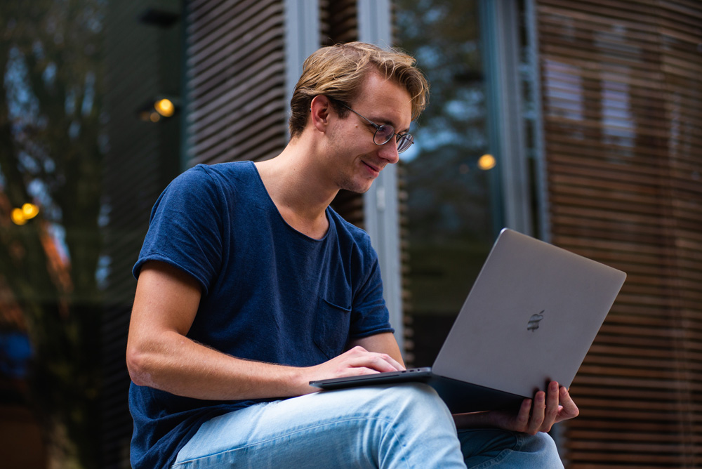 man watching video on laptop