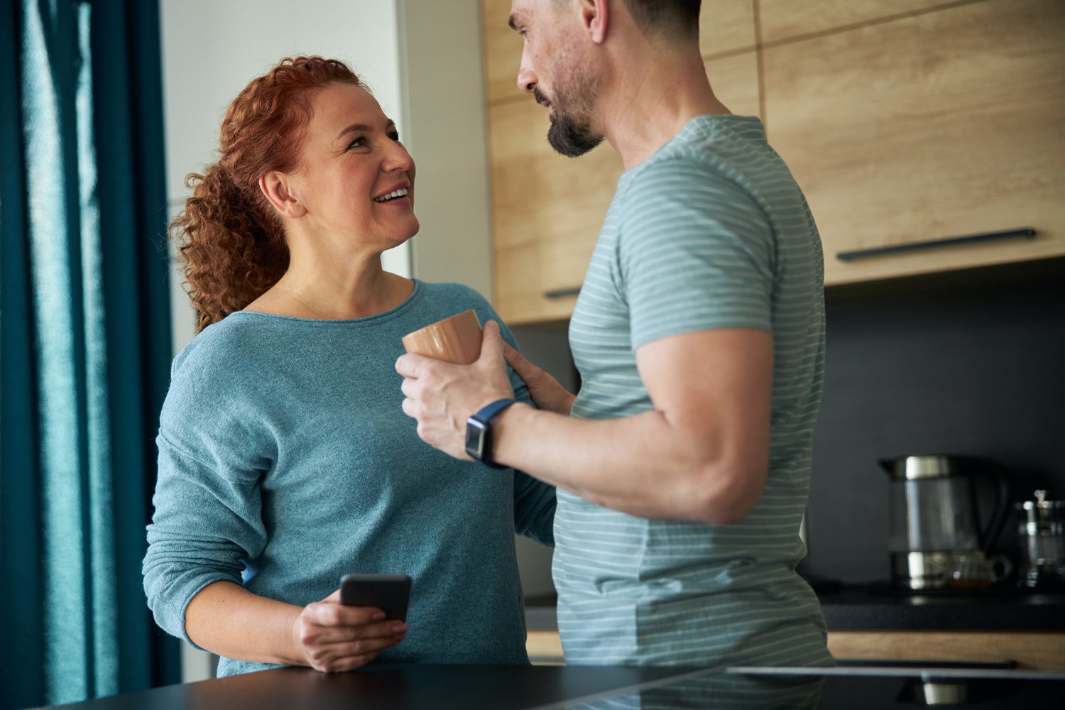 man and woman standing in the kitchen