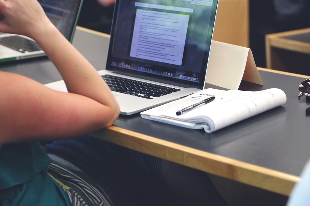 person studying with laptop computer