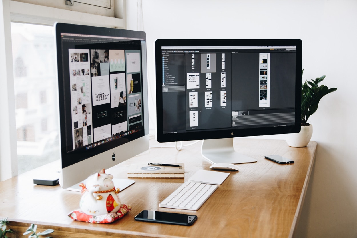 two computers displaying web designs