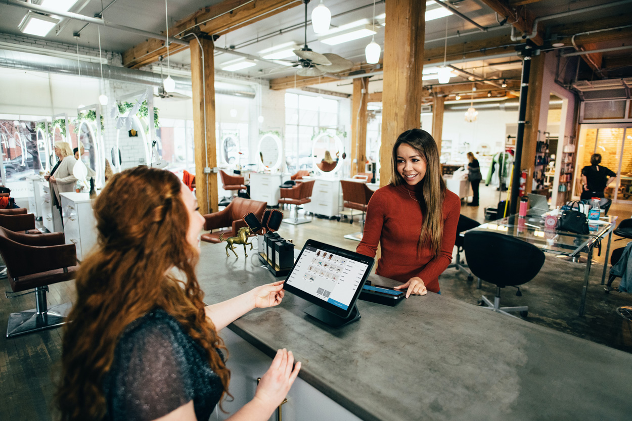 woman paying at hair salon